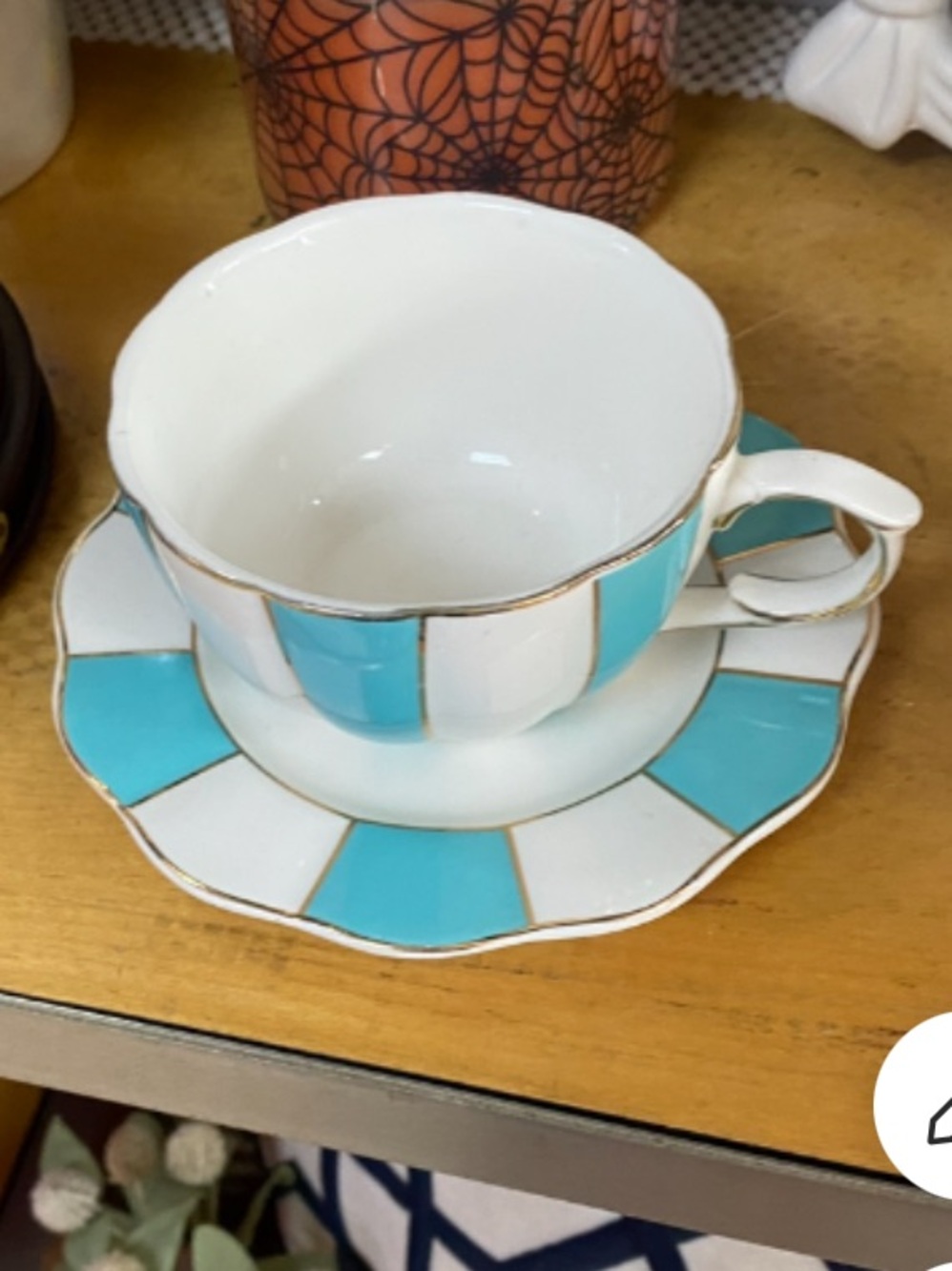 Cynthia Rowley porcelain tea cup and saucer. Aqua white panels gold bands.